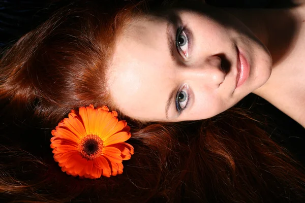 Red flower in hair — Stock Photo, Image