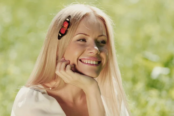 Woman playing with a butterfly — Stock Photo, Image