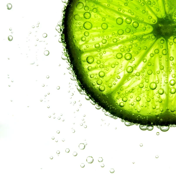 Lime slice in water — Stock Photo, Image
