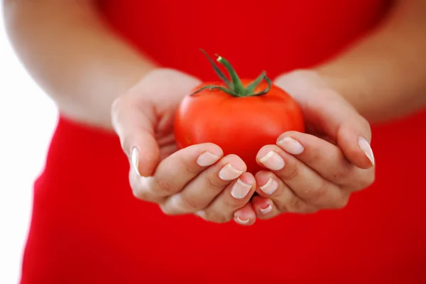 Tomato in woman hands — Stock Photo, Image