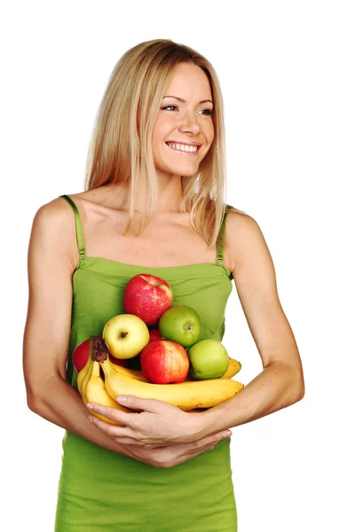 Mujer sostiene una pila de fruta — Foto de Stock