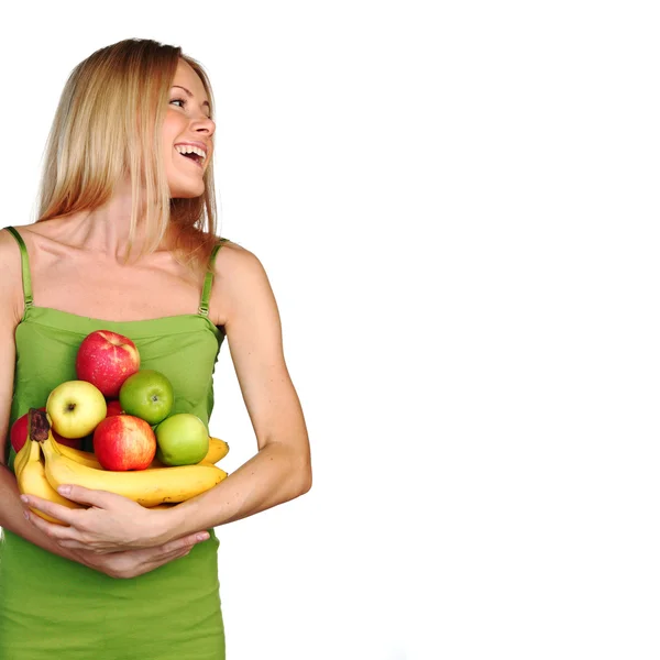 Woman holds a pile of fruit — Stock Photo, Image