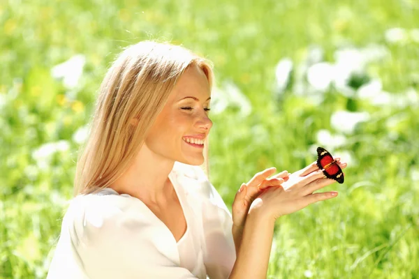 Woman playing with a butterfly Stock Photo