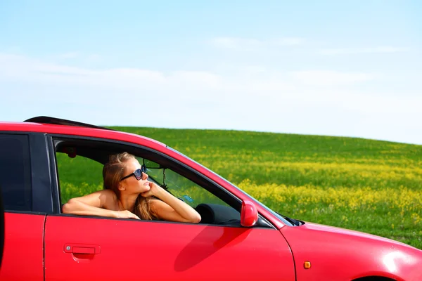 Woman in red car — Stock Photo, Image