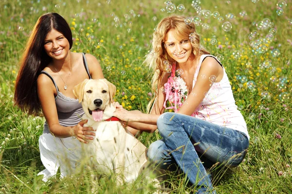 Girlfriends and dog Stock Picture