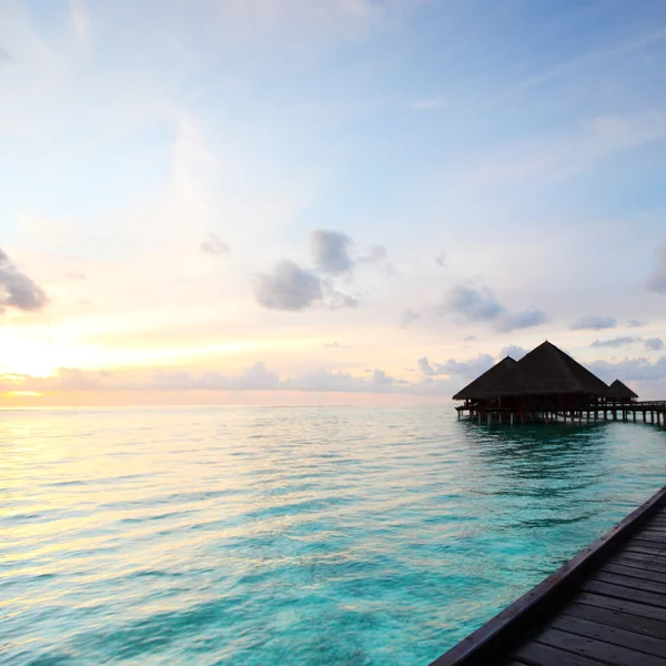 Maldivian houses on sunrise — Stock Photo, Image