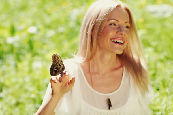Woman playing with a butterfly Stock Photo