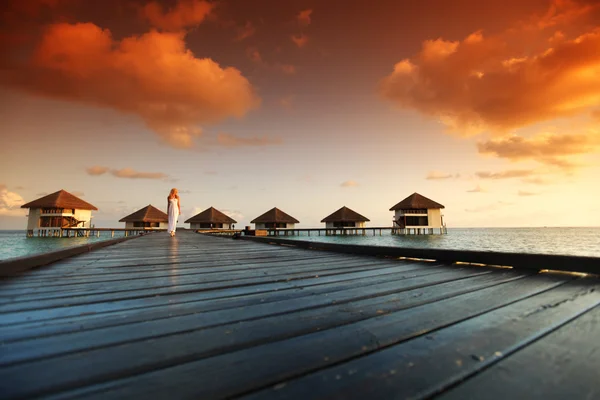 Woman in a dress on maldivian sunset — Stock Photo, Image