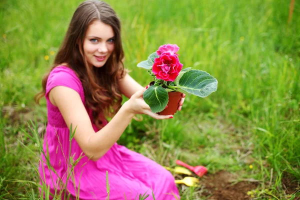 Girl grow flower — Stock Photo, Image