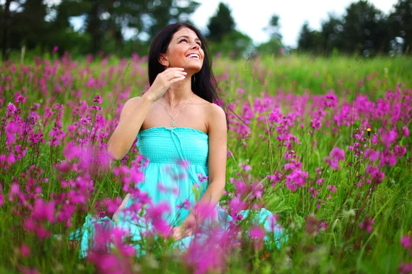 Kvinna på rosa blomma fältet — Stockfoto