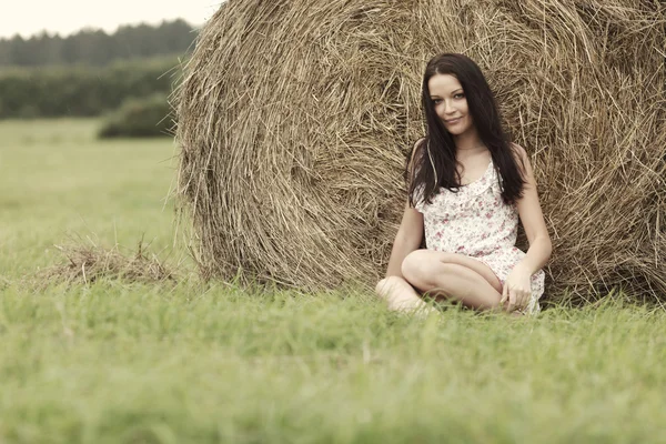 Girl next to haystack — Stock Photo, Image