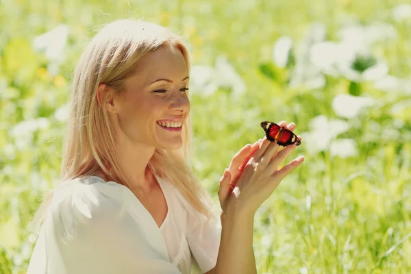 Woman playing with a butterfly Royalty Free Stock Images
