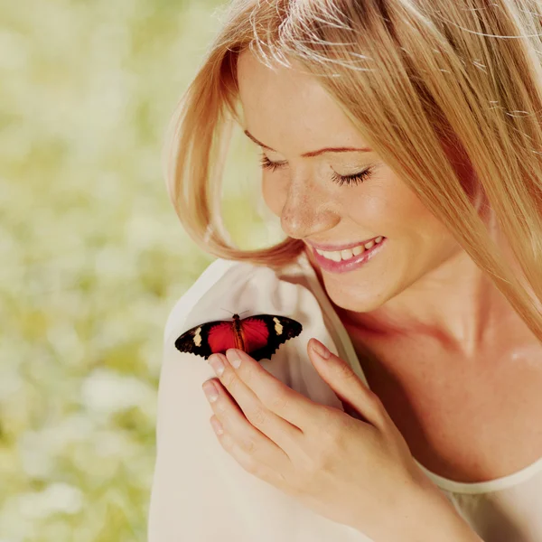 Woman playing with a butterfly Royalty Free Stock Photos
