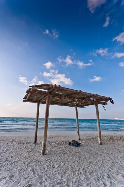 stock image Wooden canopy on the sandy beach and blue sky