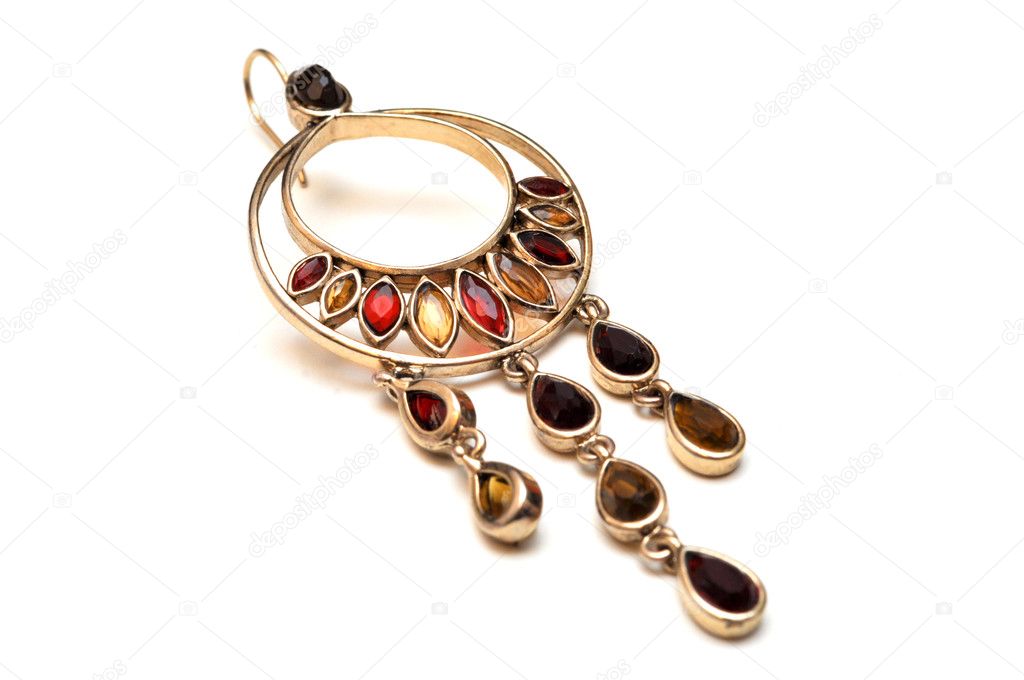 Gold jewelry earrings with red and brown stones isolated on white background