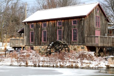 Old water mill in Waterloo, Ontario in snowy day. clipart