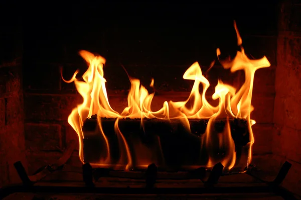 Hořící poleno v krbu — Stock fotografie