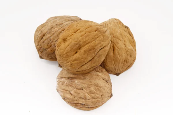 Four walnuts on the white background — Stock Photo, Image