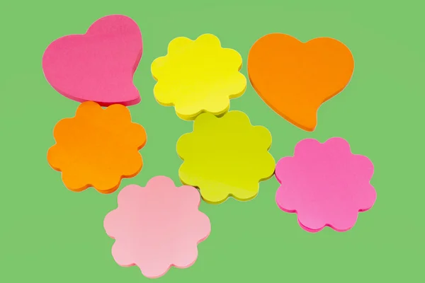 stock image Colorful sticky notes isolated on green background