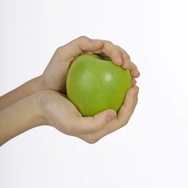 Big green apple in beautiful female hands — Stock Photo, Image