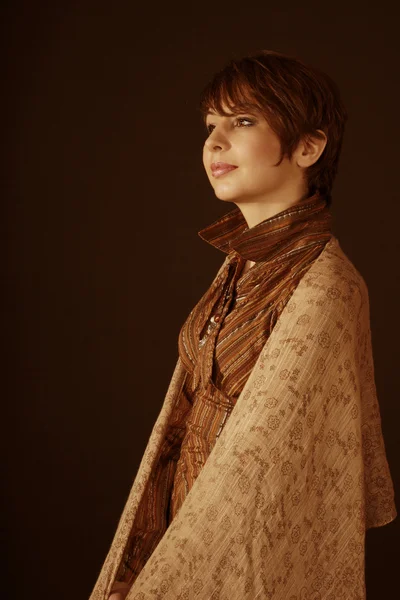 Lady in retro dress and scarf on dark backround, studio photo — Stock Photo, Image