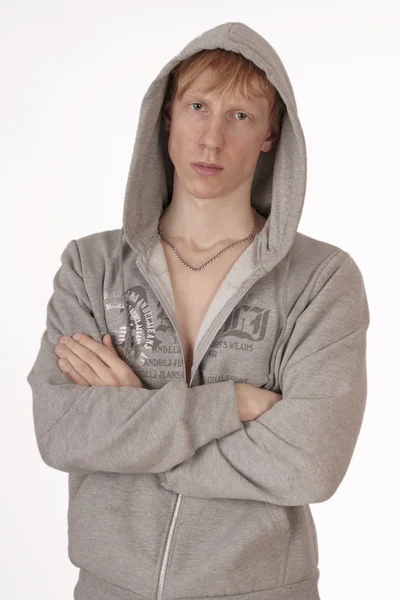 Fiatal jóképű férfi, egy kapucnis, elszigetelt fehér background — Stock Fotó