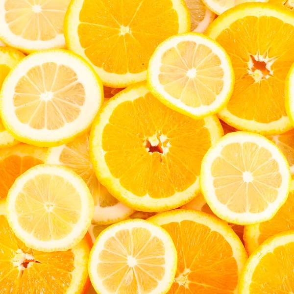 Slices of oranges, lemons, citrus background — Stock Photo, Image
