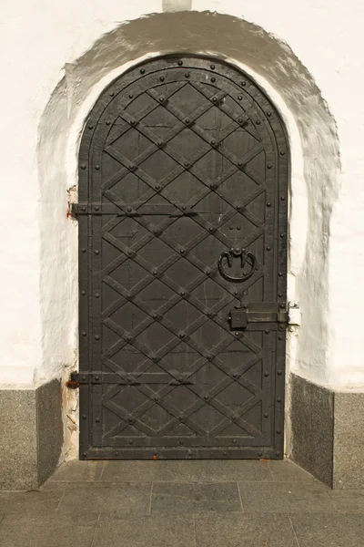 stock image Black iron doors in old building church