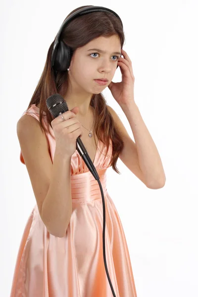 stock image Nice teen girl with microphone and headphones, singing