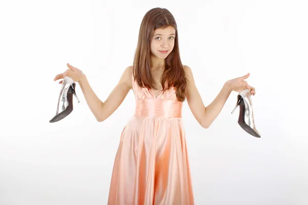 A girl holding up shoes with a smile on her face — Stock Photo, Image