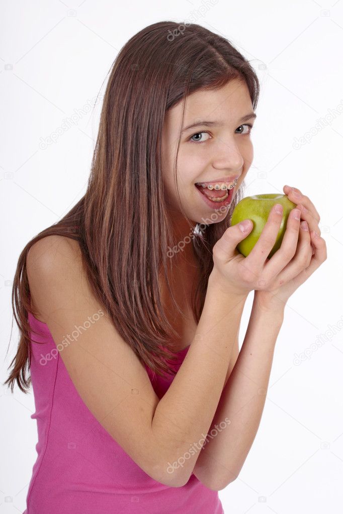 Pretty girl with open mouth eating green ripe apple