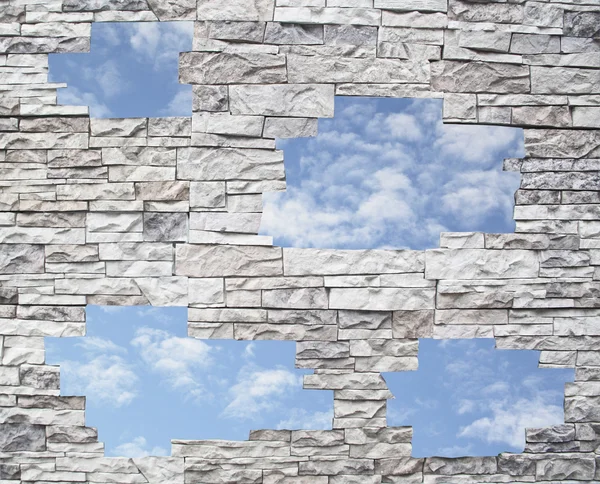 Eine Steinmauer mit blauem Himmel in den Fenstern — Stockfoto