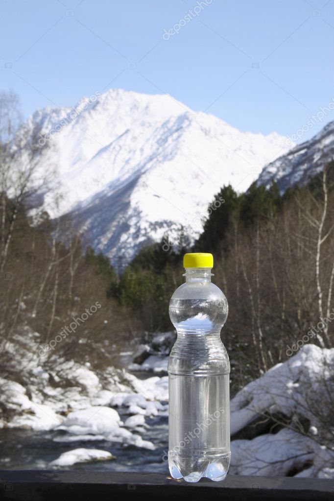 A bottle of pure water against majestic snow top