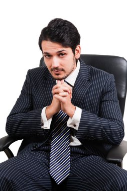 Confident businessman sitting on office chair clipart