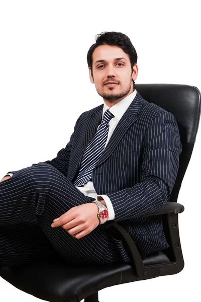 Confident businessman sitting on office chair — Stock Photo, Image
