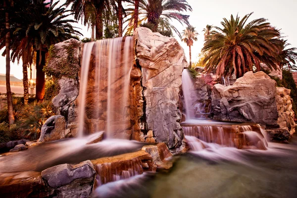stock image Artificial waterfall with palm trees
