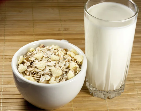 Glass of milk and a cup of muesli — Stock Photo, Image