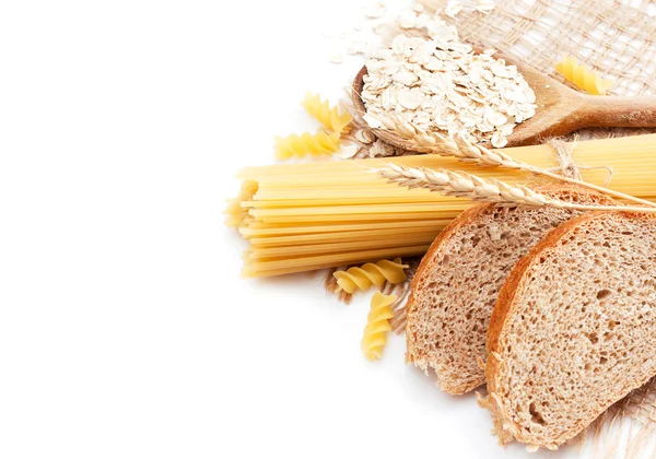 Fresh bread with wheat spikes, oat flakes and macaroni — Stock Photo, Image
