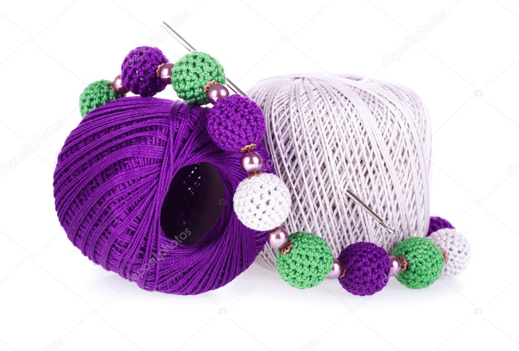 Two balls of cotton knitting yarn with crochet and knitted necklace