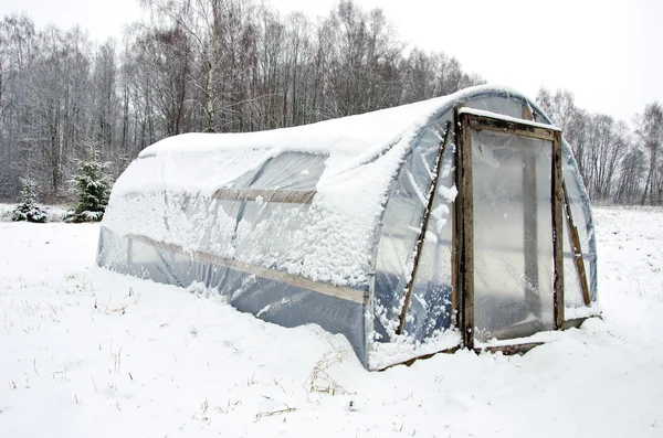 stock image Wooden diy homemade greenhouse polythene snow