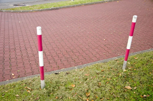 Tiled park lane and protective barrier stakes — Stock Photo, Image
