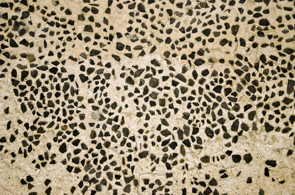 Wall decorated with small flint stones backdrop — Stock Photo, Image