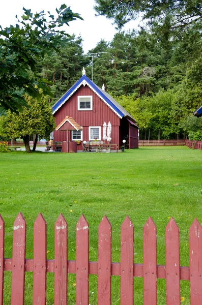 Wooden colorful house well fence rural homestead — Stock Photo, Image