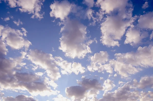 Cloudy blue spring sky sun-lit background — Stok fotoğraf