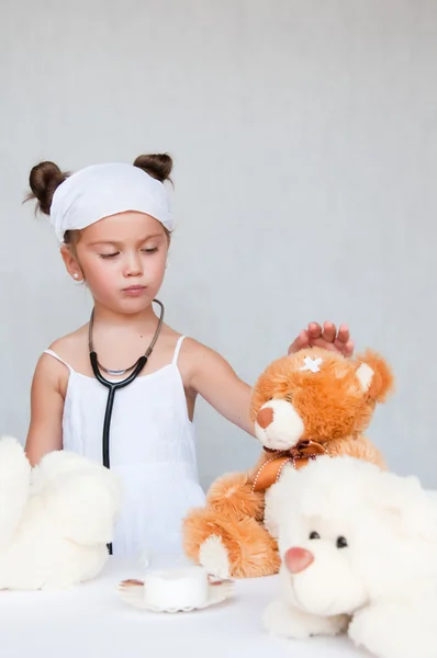 Little girl doctor with teddy bear — Stock Photo, Image