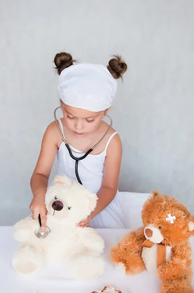 Little girl doctor with teddy bear Stock Photo