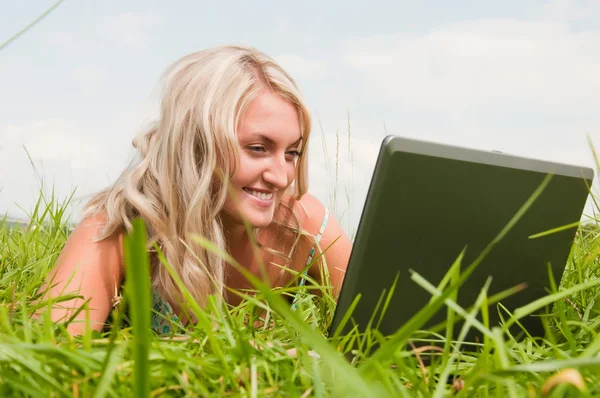 Beautiful girl on the meadow with notebook — Stock Photo, Image