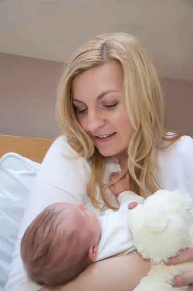 Portrait of young happy mother with newborn baby at home — Stock Photo, Image