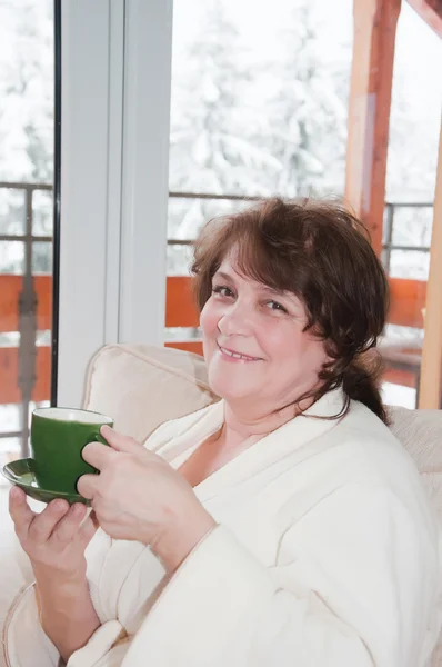 Elderly woman drink coffee at home — Stock Photo, Image
