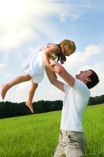 Father and daughter playing in the meadow — Stock Photo, Image